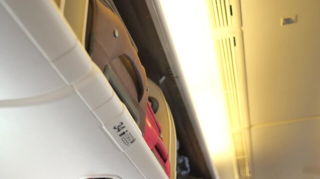 A low-angle cinematic shot captures the motion of a train journey, featuring luggage in overhead compartments and bright interior lights, highlighting the dynamic travel experience