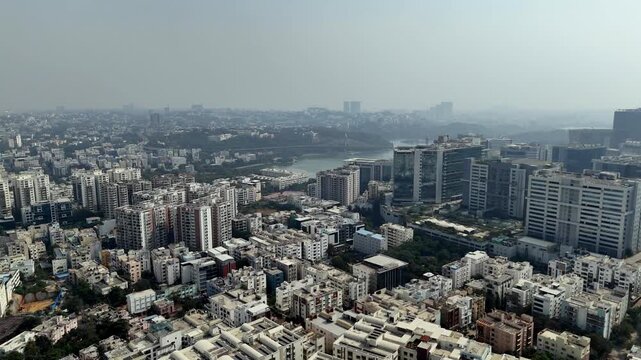 Durgam Cheruvu glimmers beside Hyderabad&rsquo;s tech skyline&mdash;an urban lake framed by glass towers, dense housing, and the city&rsquo;s signature haze.