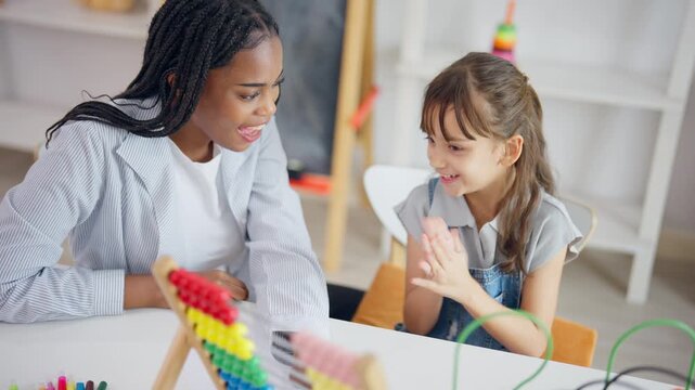 African tutor use educational abacus help a child learn basic math skill.