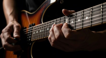 Obraz premium Close Up Hands Playing Electric Guitar in Dark Studio