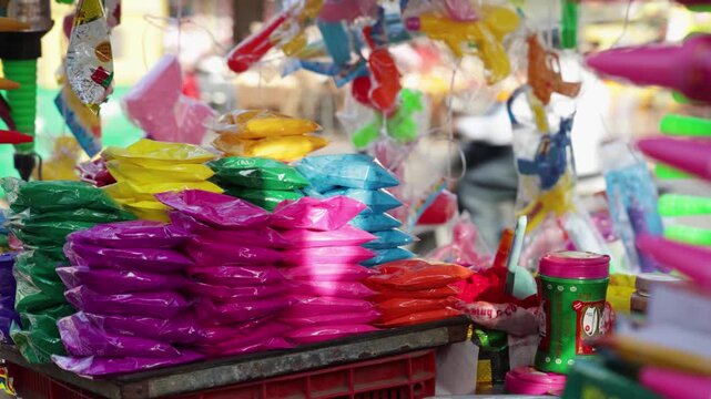 multicolored festival powder packets arranged for holi celebration sale