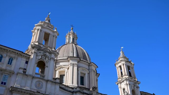 The dramatic concave Baroque facade and twin bell towers of Sant Agnese in Agone church facing the Fountain of the Four Rivers in the historic city center