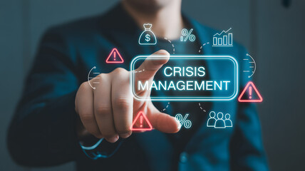 Obraz premium Businessman interacting with virtual crisis management interface with warning signs and financial symbols in a professional setting