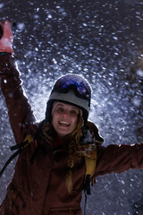 Snowy evening in the mountains with a person celebrating and enjoying winter sports during heavy snowfall