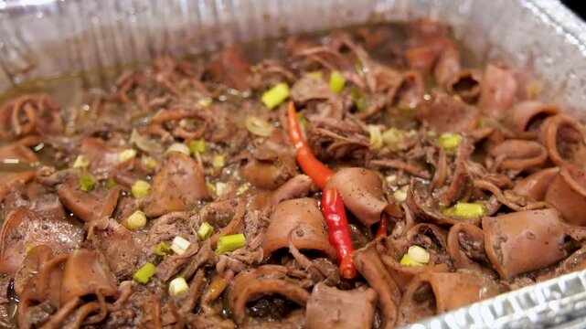 Cooking adobong pusit in the Philippines with simple steps for a tasty seafood dish
