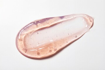 Fototapeta premium Translucent pink cosmetic gel smear with a glossy finish and small bubbles on a white surface