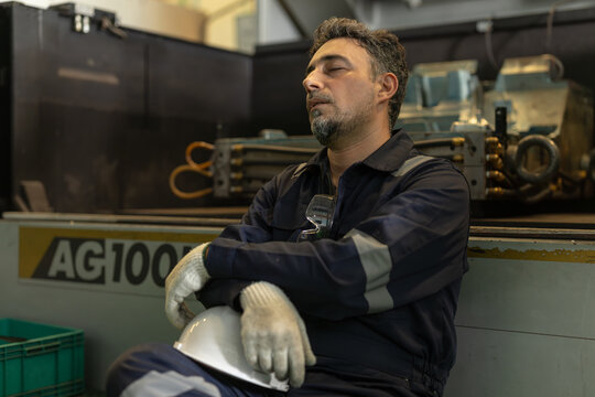Mature Adult Engineer Worker male rest nap at workplace Tired Fatigue Exhausted from hard work