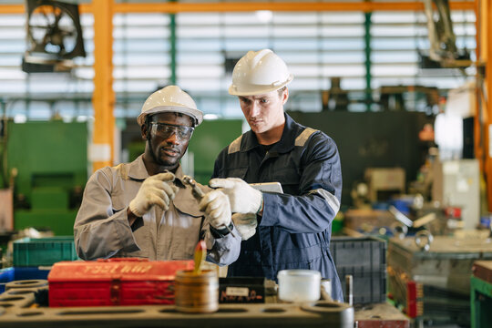 Professional Technician Engineer Training Team Cooperate together check inspecting part quality.