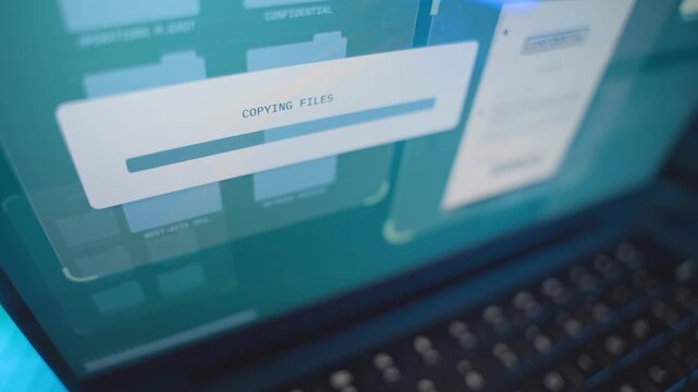 Close up on computer screen progress bar copying secret files from government server. Spy or hacker stealing information and sensitive data from agency or business. Folders being moved in cybercrime