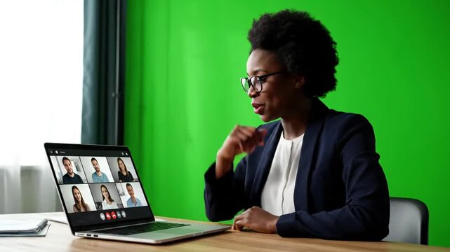 Woman in video call with remote work office.