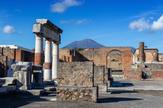 Pompeii Ancient Roman Archaeological Ruins, UNESCO World Heritage Site.  Famous Mount Vesuvius Active Volcano Landcape on Skyline, Campania Italy