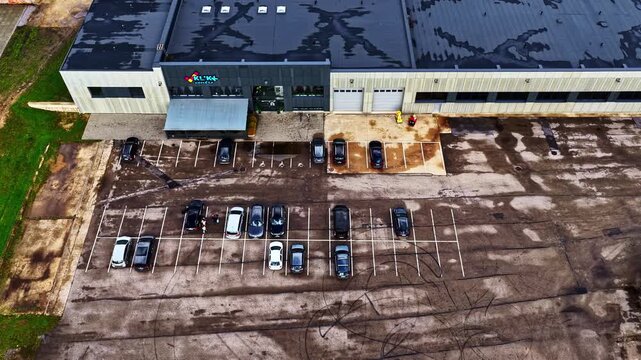 Aerial overview of commercial building with loading dock doors and parking