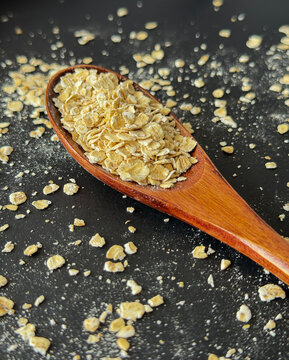 Quick Oats on Wooden Spoon Dark Food Background
