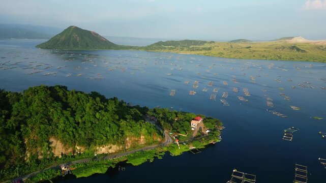Slow pan shot of Agoncillo baywalk, Binitiang Malaki western point of Taal Volcano at Agoncillo Laurel Batangas Philippines.