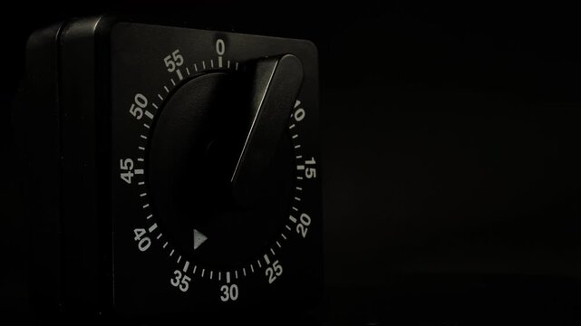 Time lapse of a kitchen clock timer countdown to zero.