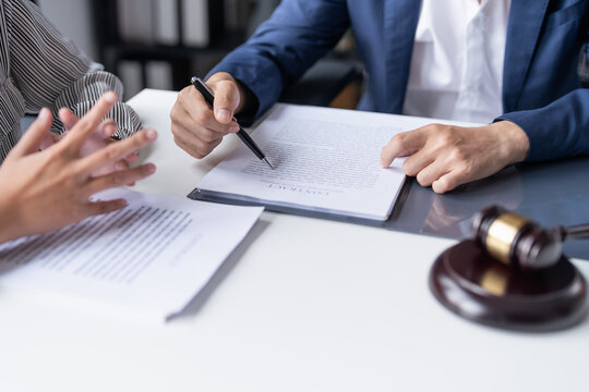 Lawyer businessman working&nbsp;with lawbook in office&nbsp;or courtroom Legal counsel with gavel and legal law. justice and lawyer concept Judge gavel hammer on Lawyer desk.