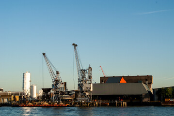 Obraz premium Industrial port harbor with cranes and cargo barge