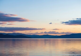 Fototapeta premium Sunset over a calm lake with colorful clouds and distant mountains