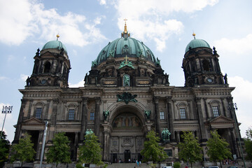 The majestic green domes and ornate facade of the Berlin Cathedral on Museum Island