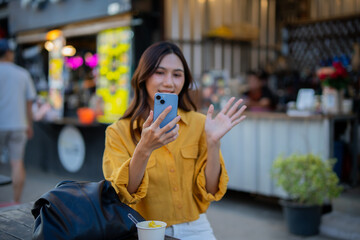 Fototapeta premium Asian women enjoy delicious street food at night markets, smiling throughout their vacation, exploring the city's culture, vibrant lights, and fun-filled adventures.