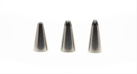 Three icing nozzles isolated on a pristine white background, showcasing different metal tips for cake decoration