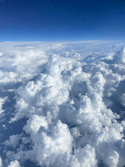 Beautiful view of airplane wing above Caribbean Sea with scattered clouds during flight departure from Curacao.