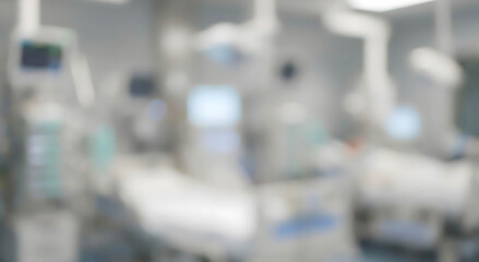 Obraz premium Blurred image of a hospital room containing multiple medical devices, equipment, and beds. The environment appears sterile and designed for patient care.