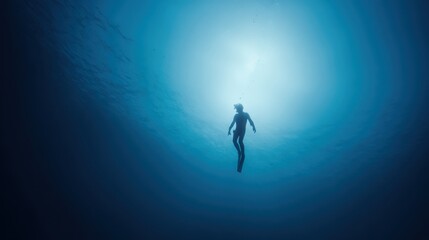 Silhouette of Freediver Ascending Towards Sunlight