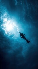 Fototapeta premium Silhouette of Diver in Deep Blue Ocean