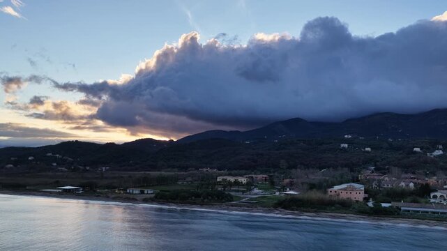 Aerial Drone View of Seaside Resort Hotel with Swimming Pool on Acharavi Coastline under Cloudy Sunset Sky in Corfu Greece
