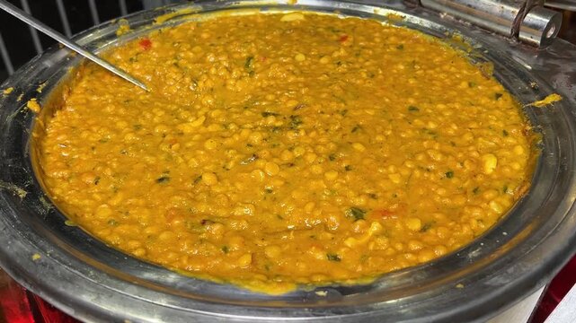 Traditional Bengali chana dal infused with ginger and fennel seeds, elegantly served in a classic wedding-style bowl.