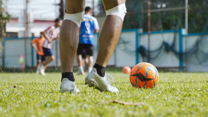 Close-up of a soccer player's legs and ball during an outdoor training session
