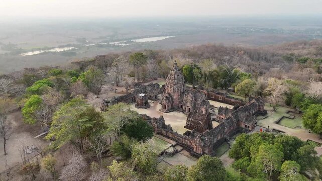 Dron orbit shot of Prasat Phnom Rung main sanctuary at golden hour, Khmer architecture in Buriram. Thailand.