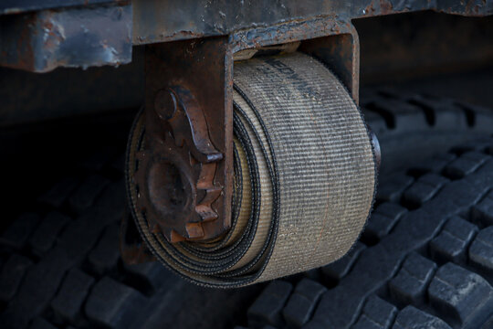 Cargo load securement ratchet strap on flatbed truck transportation safety concept