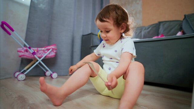A Young Child Joyfully Experiments with Objects on the Floor, Surrounded by Colorful Toys and a Cozy Home Environment, Capturing Innocence and Curiosity in Daily Life