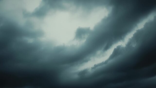 Overcast, moody sky filled edge to edge with dark storm clouds and dramatic textures, evoking an ominous, powerful atmosphere and pending rain across a wide horizon