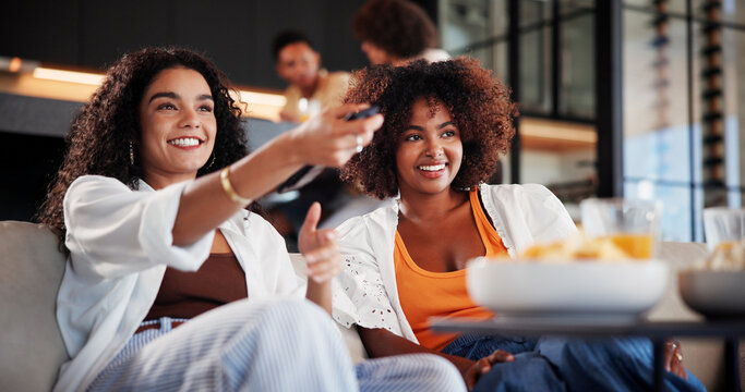 Women, friends and watching tv on sofa with smile, remote control and movie choice in living room. People, happy and relax on couch with streaming, subscription or bonding with film in lounge at home