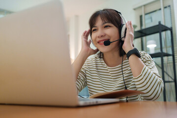 Asian girl student talking with teacher during online learning session at home