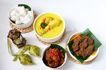 The dishes served during Eid celebrations are rendang, dendeng balado, opor ayam, and ketupat. Isolated on white background
