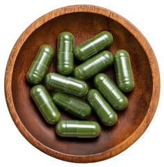 supplement capsules on a small wooden plate isolated on transparent background