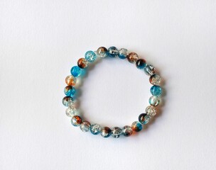 Fototapeta premium Multicolored handmade beaded bracelet with artistic texture isolated on white background.