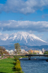 Buildings and promenade and riverside walkway at Katakami riverflowing through the middle of Morioka city, Iwate Cityscape  with Iwate Mount Background scene in Morioka,  Iwate, Japan