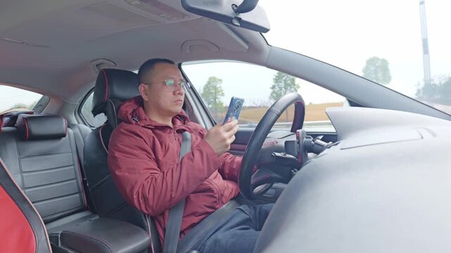A male driver&rsquo;s using his phone while driving &mdash; that&rsquo;s reckless driving.