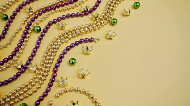 Beads decorative set with purple and gold colors and green accents arranged in wavy patterns featuring jewelry, accessories, fashion