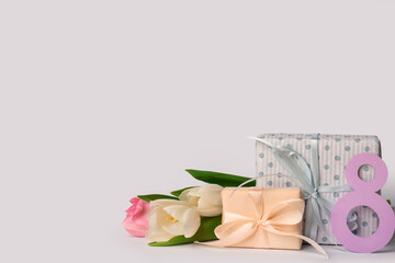 Paper figure 8 with gift boxes and tulips on white background. Happy Women's Day
