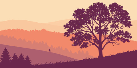 A majestic tree stands tall against a vibrant sunset over a mountainous landscape. © Rabbi