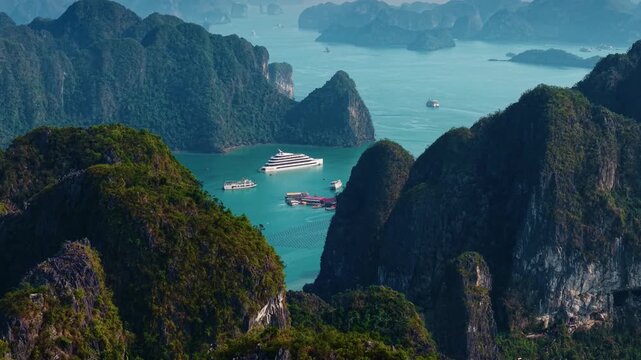 Scenic view of Halong bay with cruise boats and islands.
