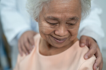 Caregiver holding hands Asian elderly woman patient with love, care, encourage and empathy at nursing hospital, healthy strong medical.