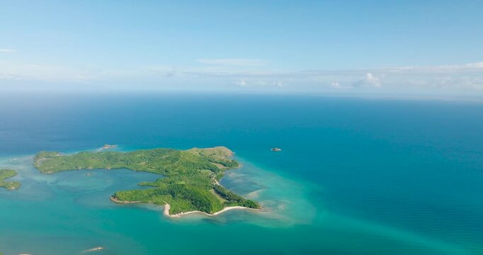 Cabangajan Island with white sand and turquoise water with corals. Santa Fe, Tablas, Romblon. Philippines.