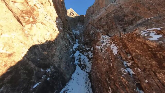 Majestic Aerial Close Up of Jagged Limestone Rock Fac and Snowy Ledges